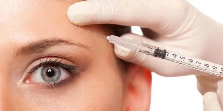 person getting botox injection above eyebrow