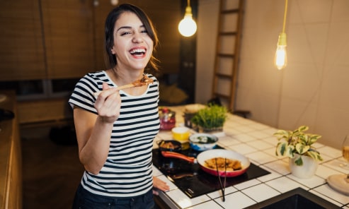 woman smiling holding utensil