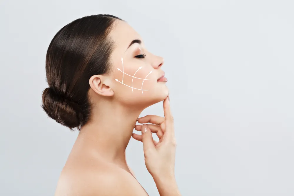 woman holding face with diagram indicating facial injection zones outlined in white