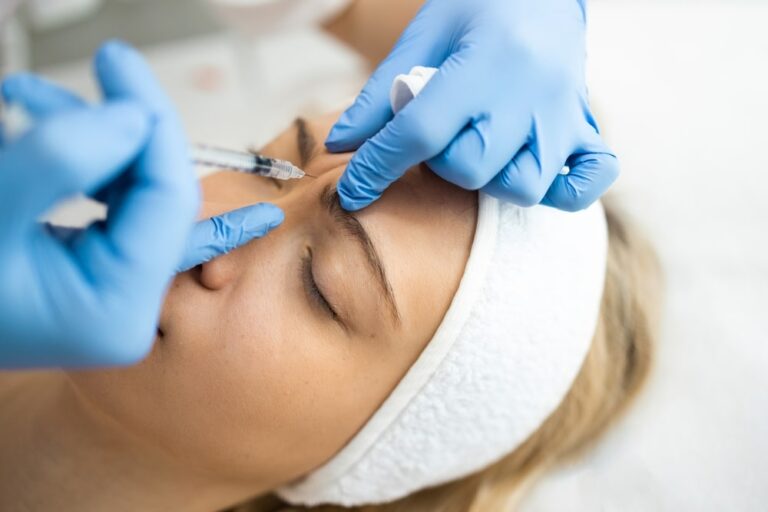 Aesthetician administering an anti-wrinkle treatment injection.