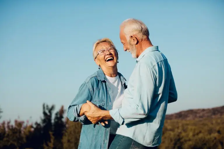 Older man and woman enjoying life, smiling and happy after health and longevity treatments from South Florida Face and Body